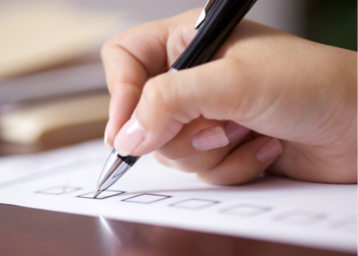 hand checking off to do list boxes.