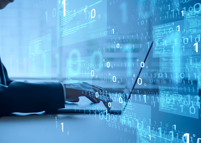 man in suit typing on keyboard ones and zeroes.