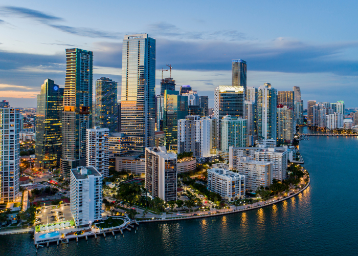 Miami Florida skyline lit in front of Miami beach.