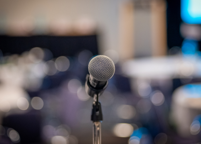 Microphone in front of blurred audience.