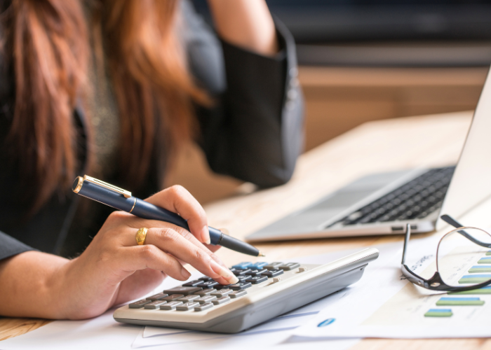 businesswoman calculating costs.