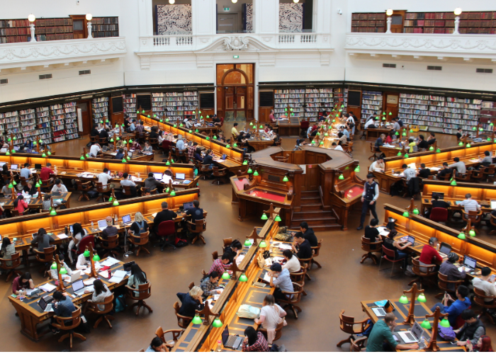 College students studying in university library.