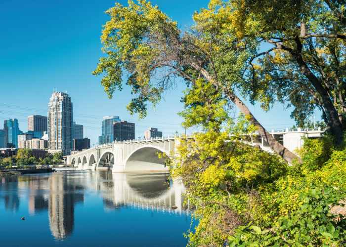 mississppi rive along bridge skyscrapers trees in reflection.