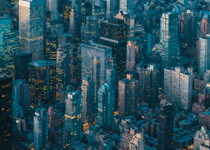 Birds eye view of new york city skyscapers at night.