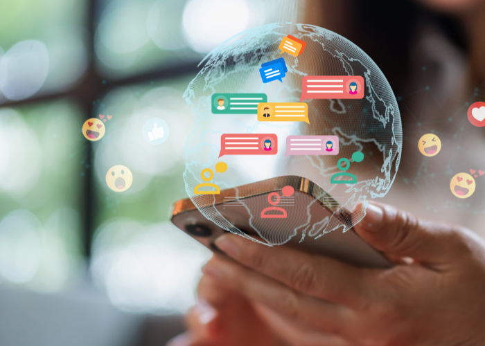 Hands scrolling through social media feed reacting with emojis.