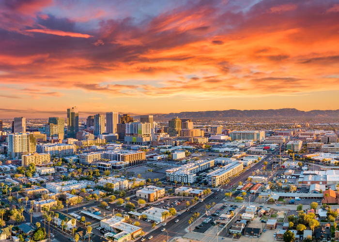 Downtown Phoenix Arizona buildings cars at sunset.