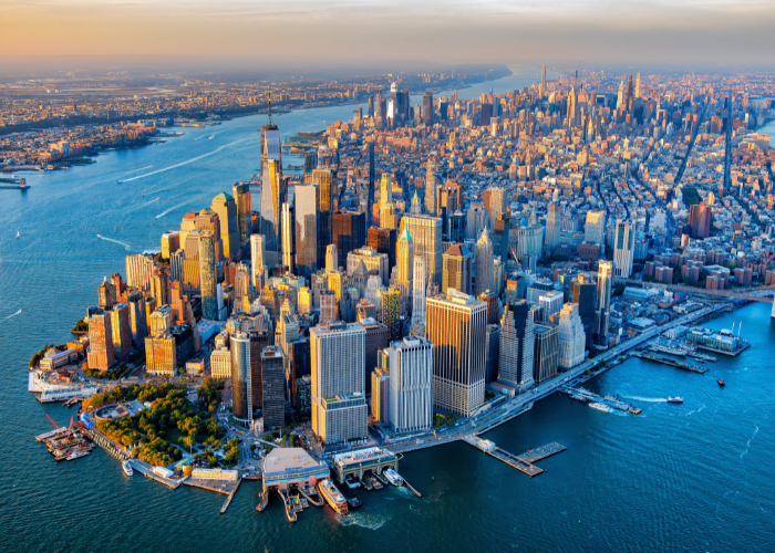 Aerial view of new york city blue water surrounding island of skyscapers.