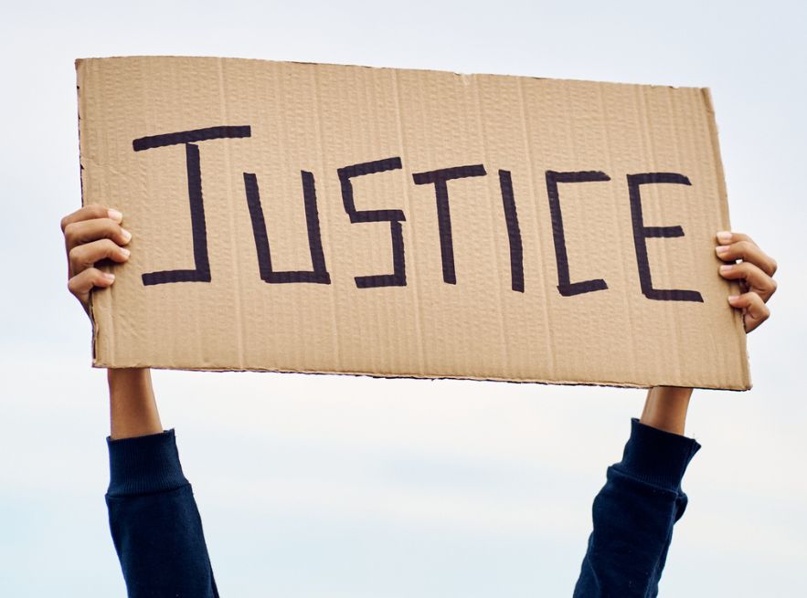 Hands raising sign for justice.