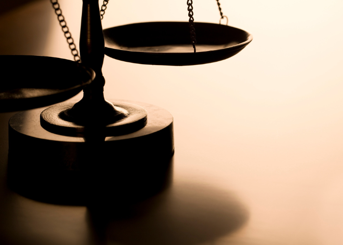 Image of a scale of justice with dramatic lighting