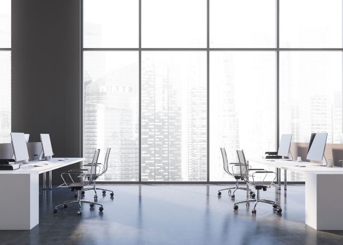 Image of modern, start-up office with large windows overlooking skyscrapers