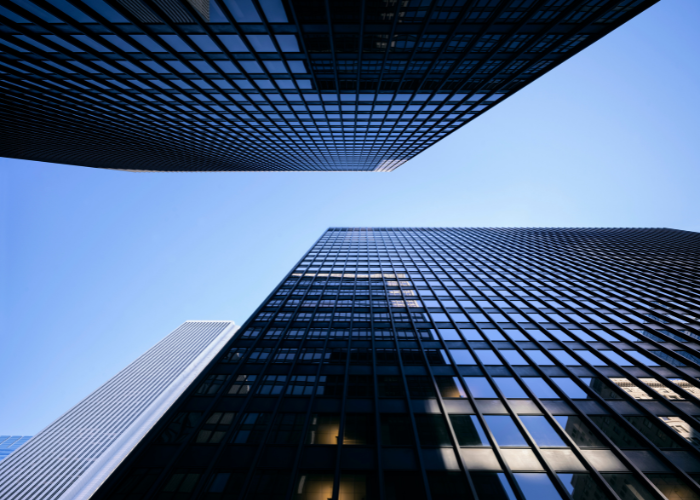 Looking up at office buildings with blue sky