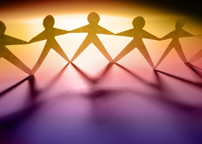 Paper people holding hands to represent human rights for U.S. Supreme Court amicus brief filing