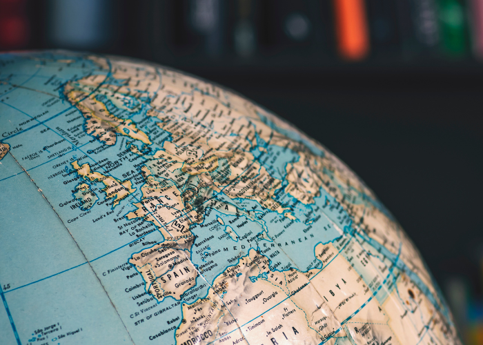 physical world globe model in front of book case.