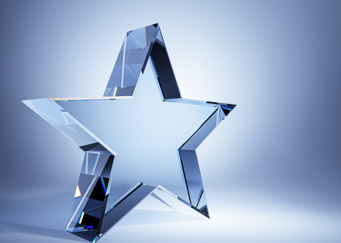 glass star trophy with spotlight shining.