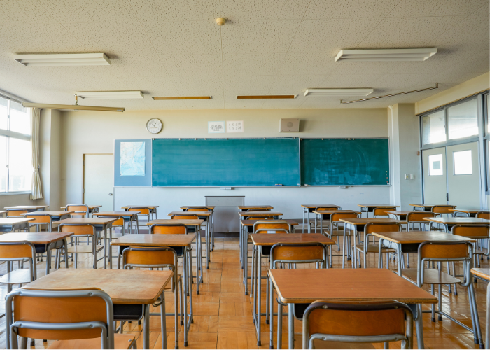 Image of empty desks in a classroom for Indian Boarding School lawsuit release