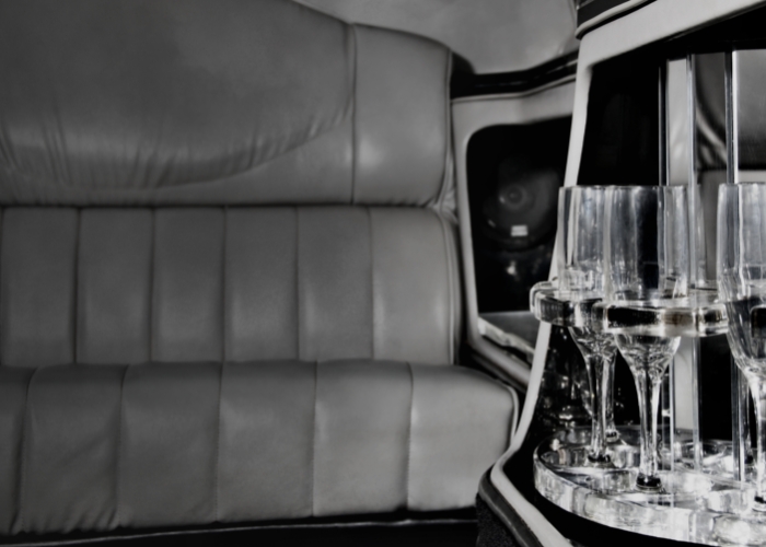 Ominous image of back of limo seat and champagne glasses