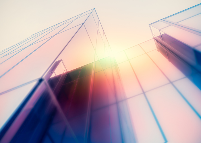 Rainbow colored glass building with sunlight reflection.