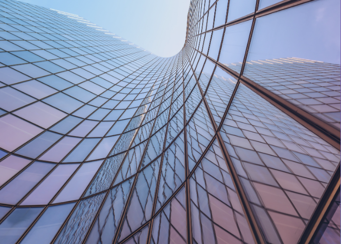 Glass skyscraper windows with purple and blue hue.