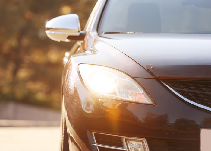 Black car with lights on.