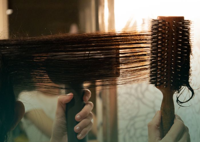 Black woman's hair being straightened by blow dryer. Image used for press release: Federal Court Allows Key Expert Testimony on Cancer Risks in Hair Relaxer Multidistrict Litigation